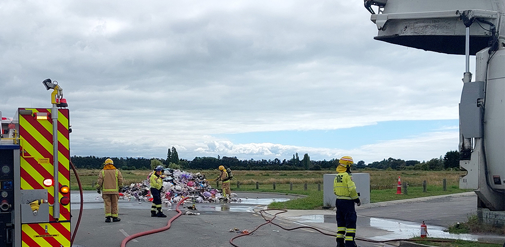 Firemen dealing with the contents of a collection truck that caught fire. Source: Waimakariri District Council.